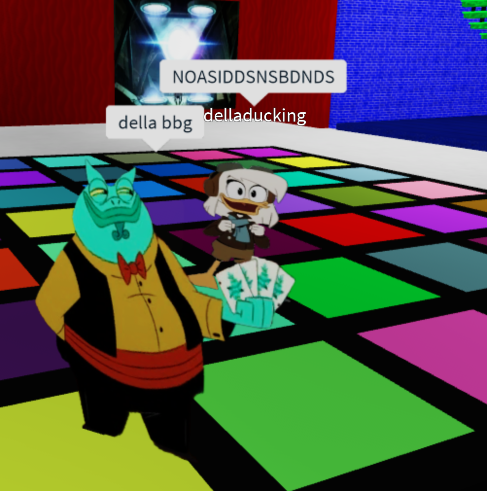 A screenshot of me and Twigs playing a Ducktales Roblox game. She's Toad Liu Hai and I'm Della Duck. There is a text bubble that reads della bbg. There is a text bubble above me that has key smashing.